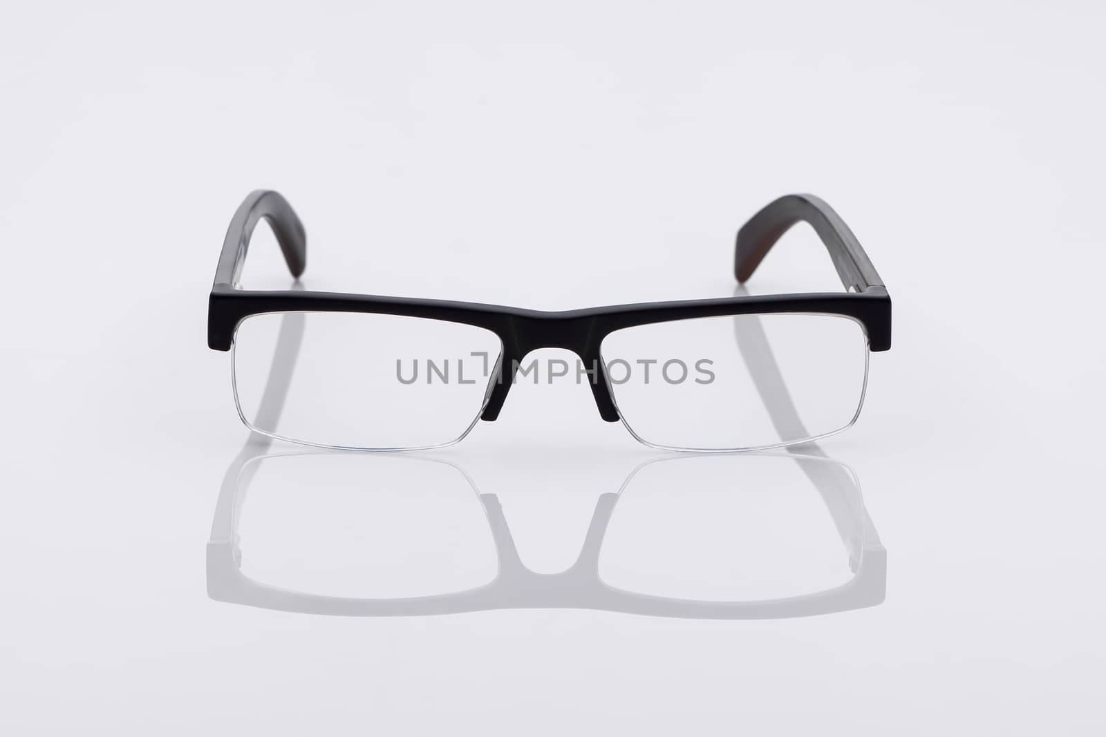classic optical glasses on a light surface with reflection