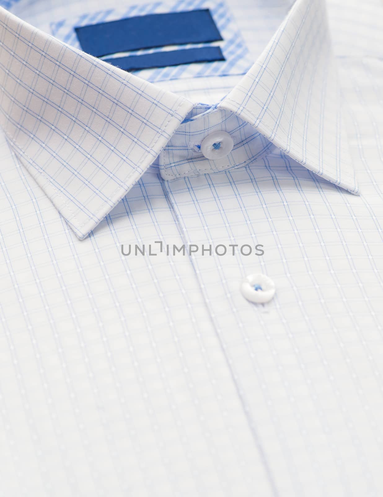 shirt with checkered pattern and with a focus on the collar and button, close-up