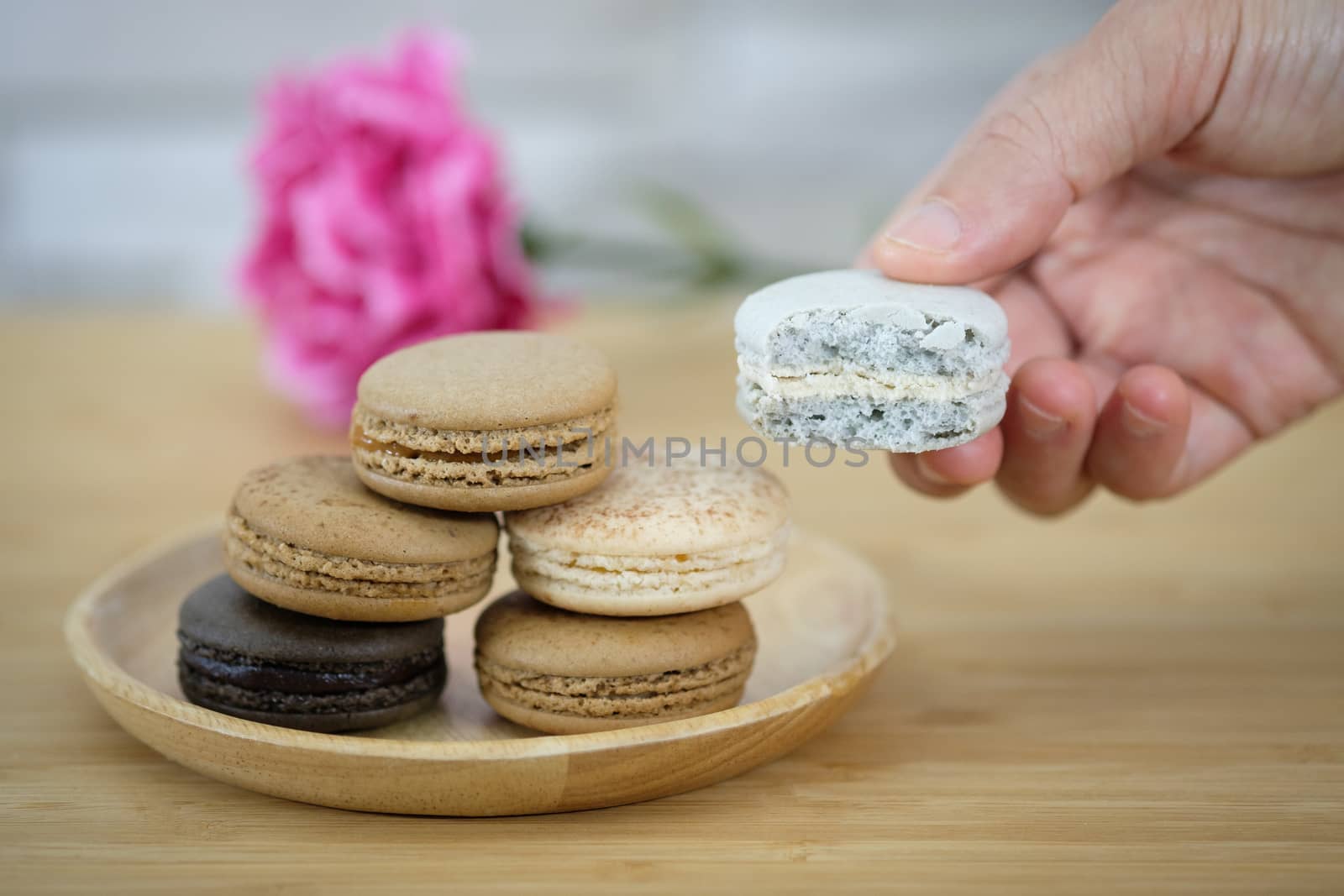 Chocolate, coffee macaroons on a  wooden table in warm light, Vintage tone.