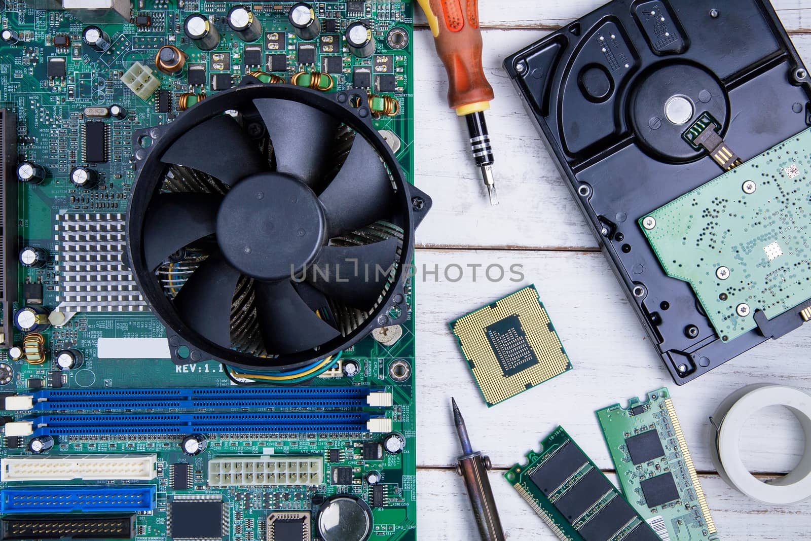 Computer motherboard, Computer Parts, Hard disk, Ram and equipment repair on the white wooden background.