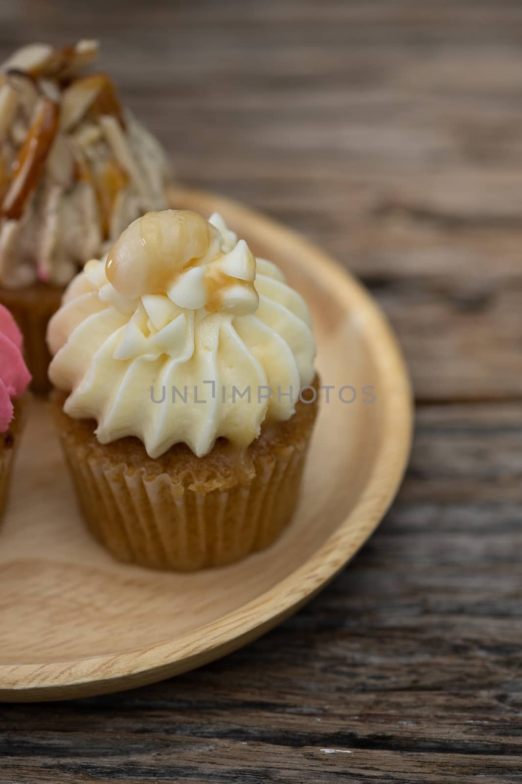 Tasty mini cupcakes on a vintage background, sweet dessert for christmas, new year and valentine holliday.