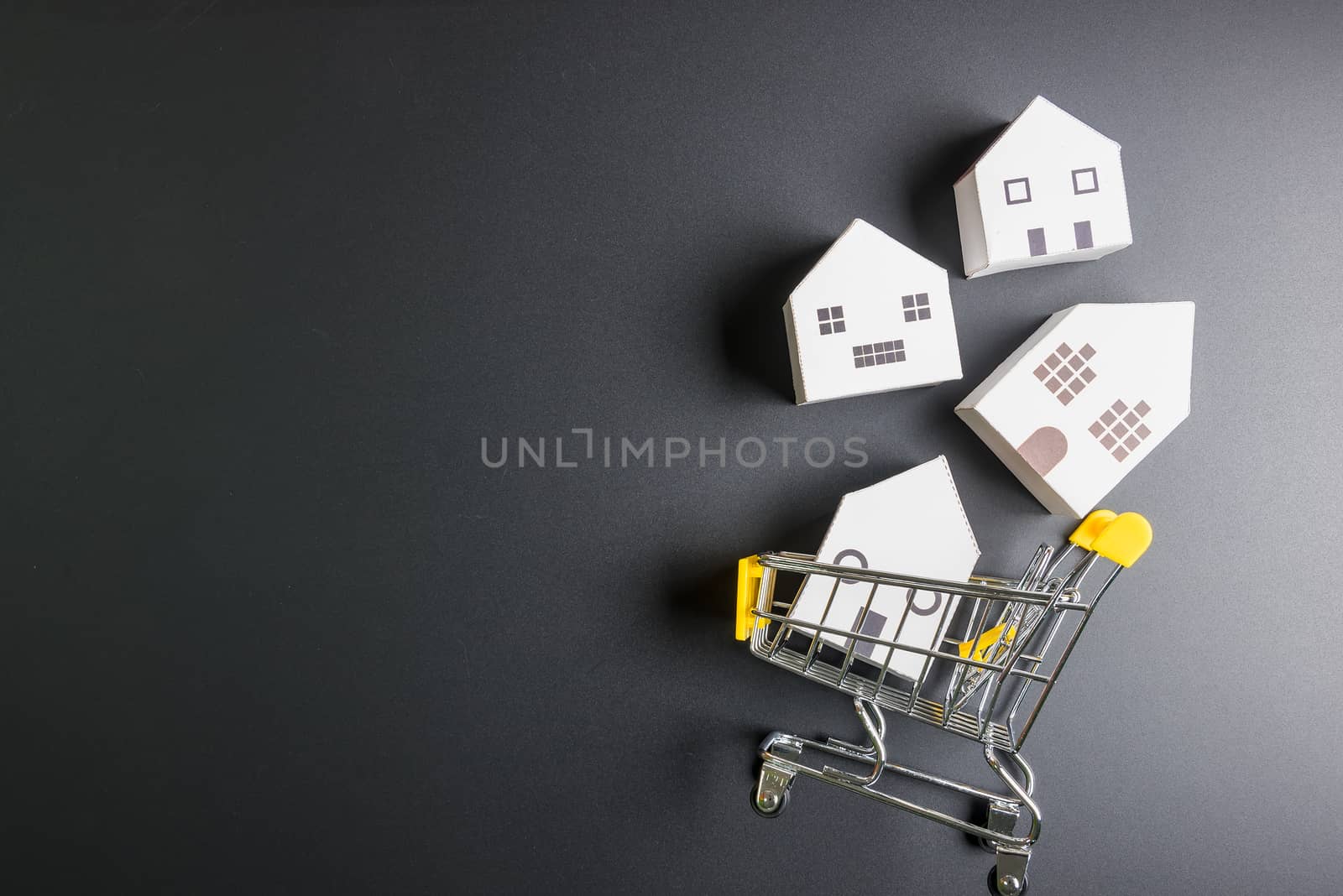 Shopping cart and  paper hose model on laptop notebook.Online shopping concept.Real estate concept, New house concept.Buying a house.