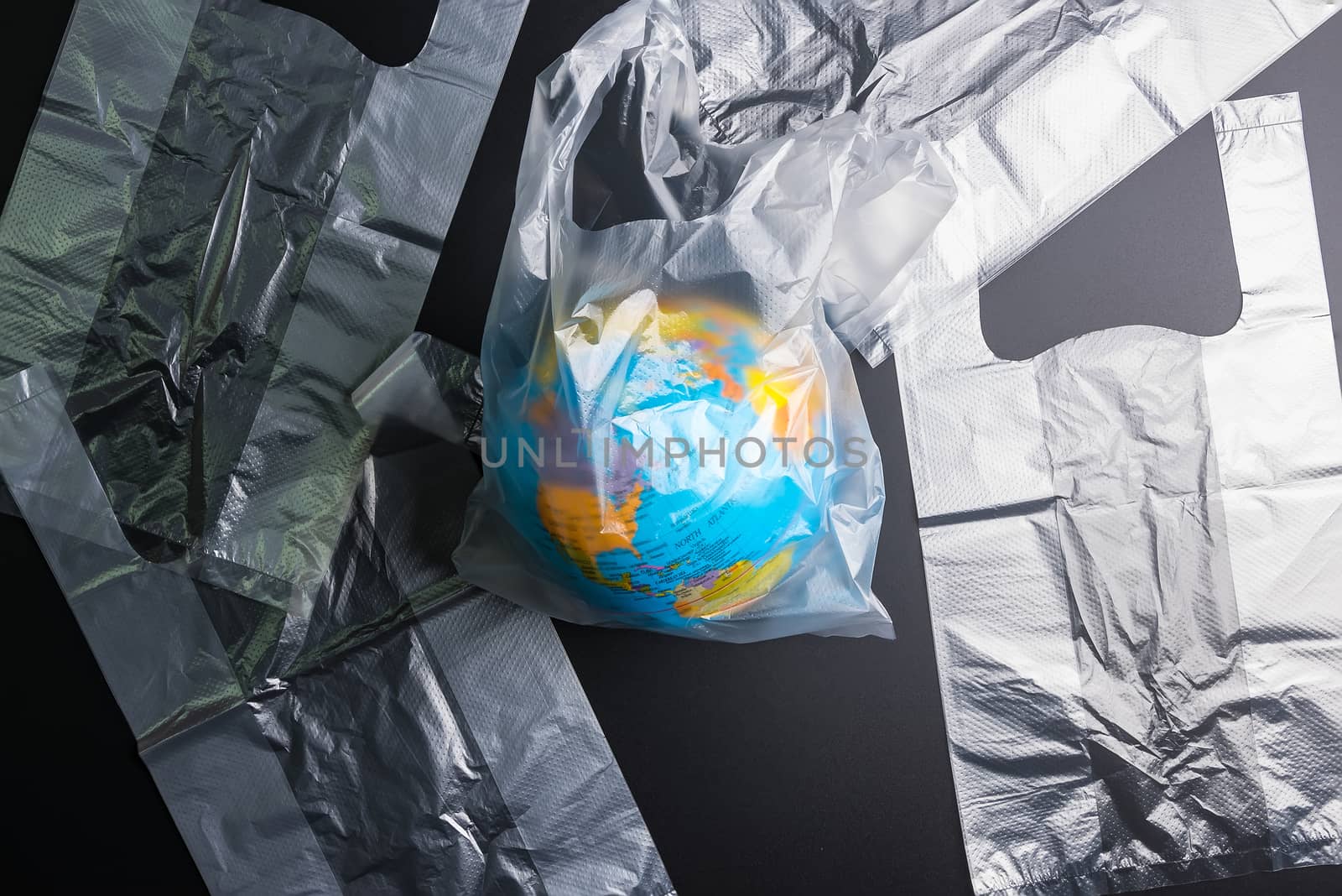 Plastic bag Earth world globe isolated on black background. Savi by Bubbers