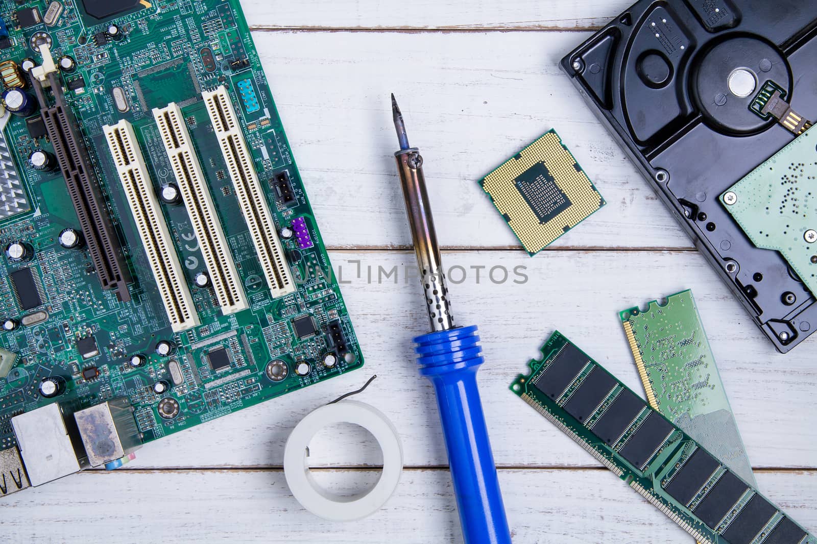 Computer motherboard, Computer Parts, Hard disk, Ram and equipment repair on the white wooden background.