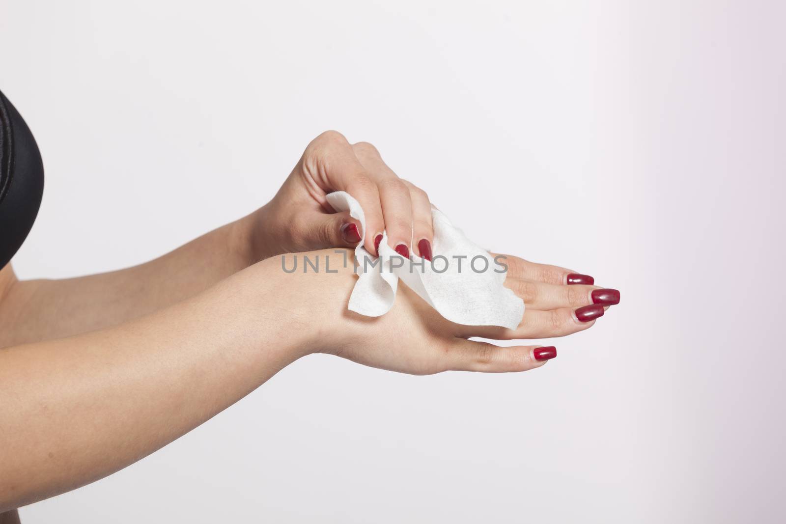 Young woman clean hands with wet wipes