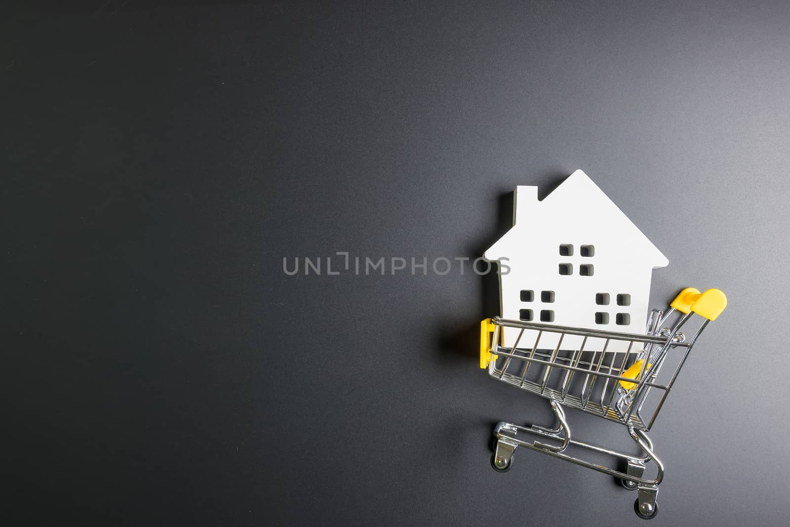 Shopping cart and wooden hose model.Online shopping concept.Real by Bubbers