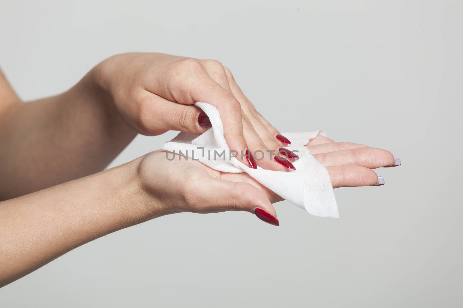 Young woman clean hands with wet wipes