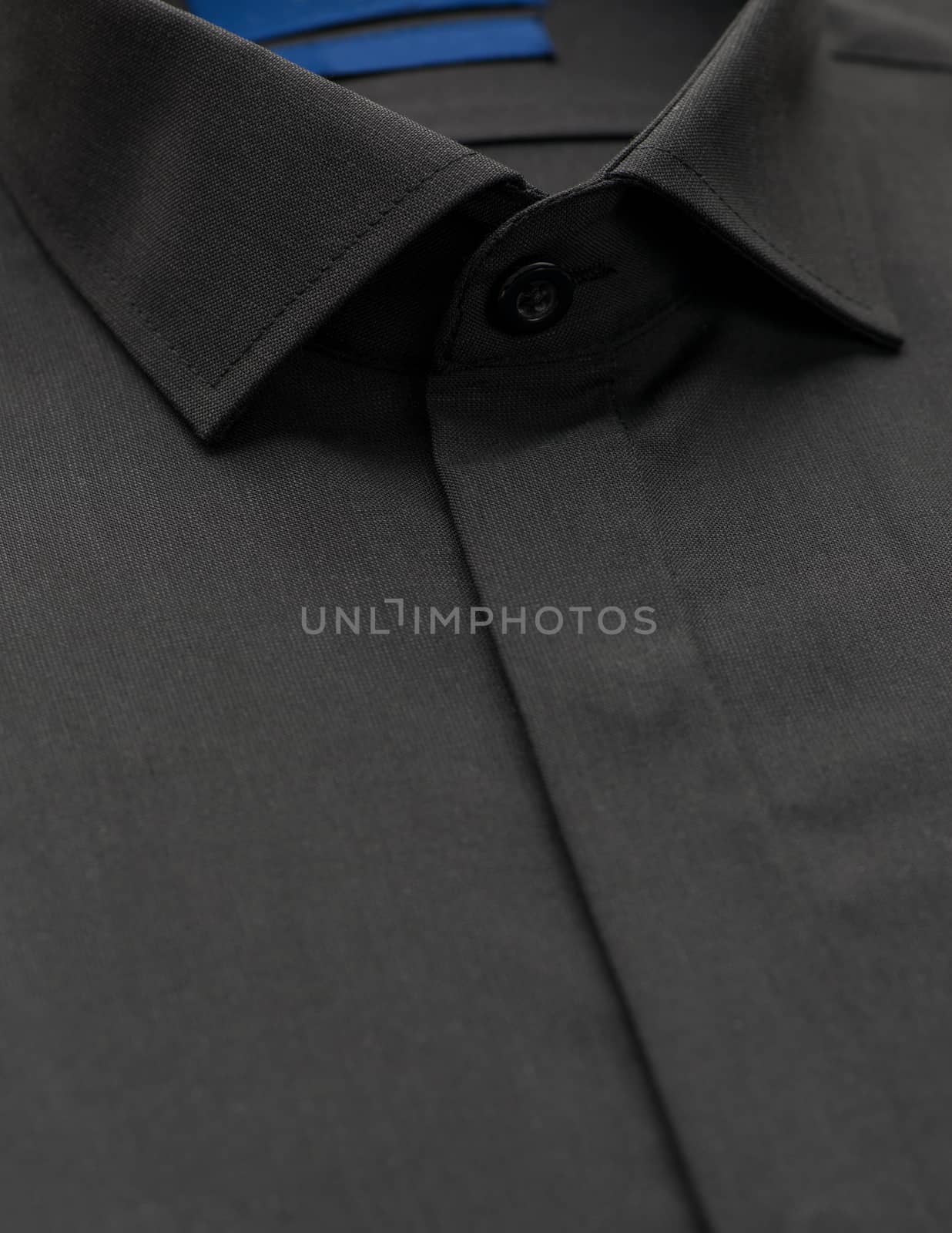 black shirt with a focus on the collar and button, close-up