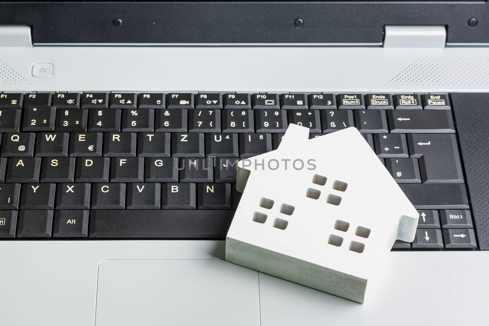 wooden white hose model on laptop notebook.Online shopping concept.Real estate concept, New house concept.Buying a house.