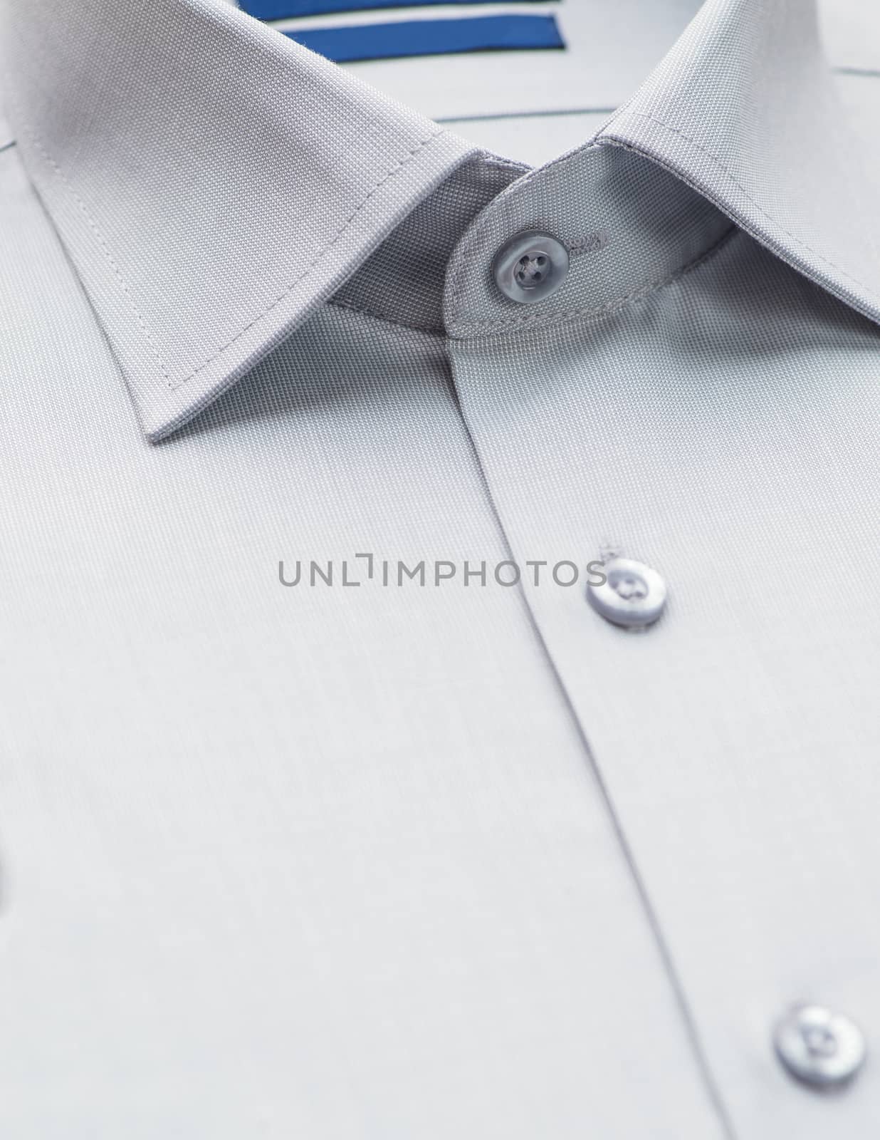 gray shirt with a focus on the collar and button, close-up