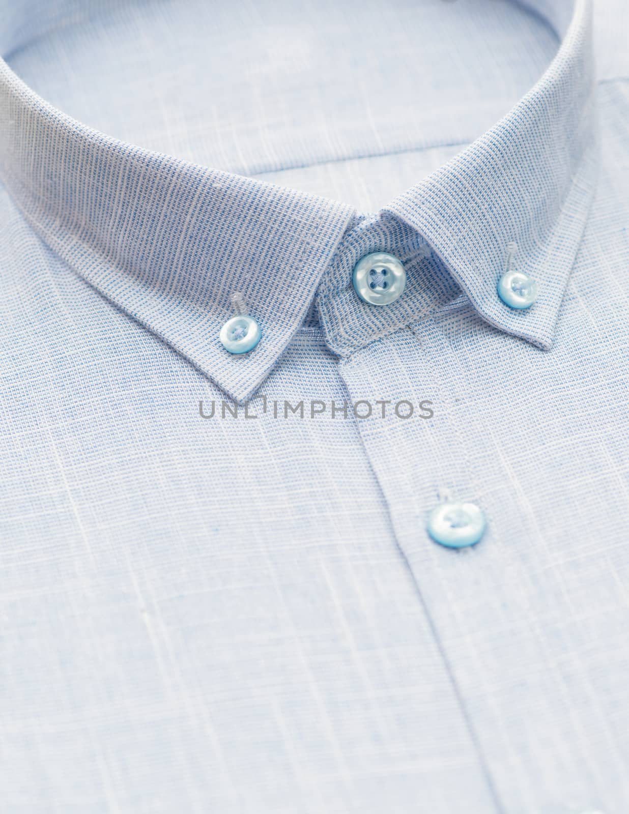 gray shirt with a focus on the collar and button, close-up