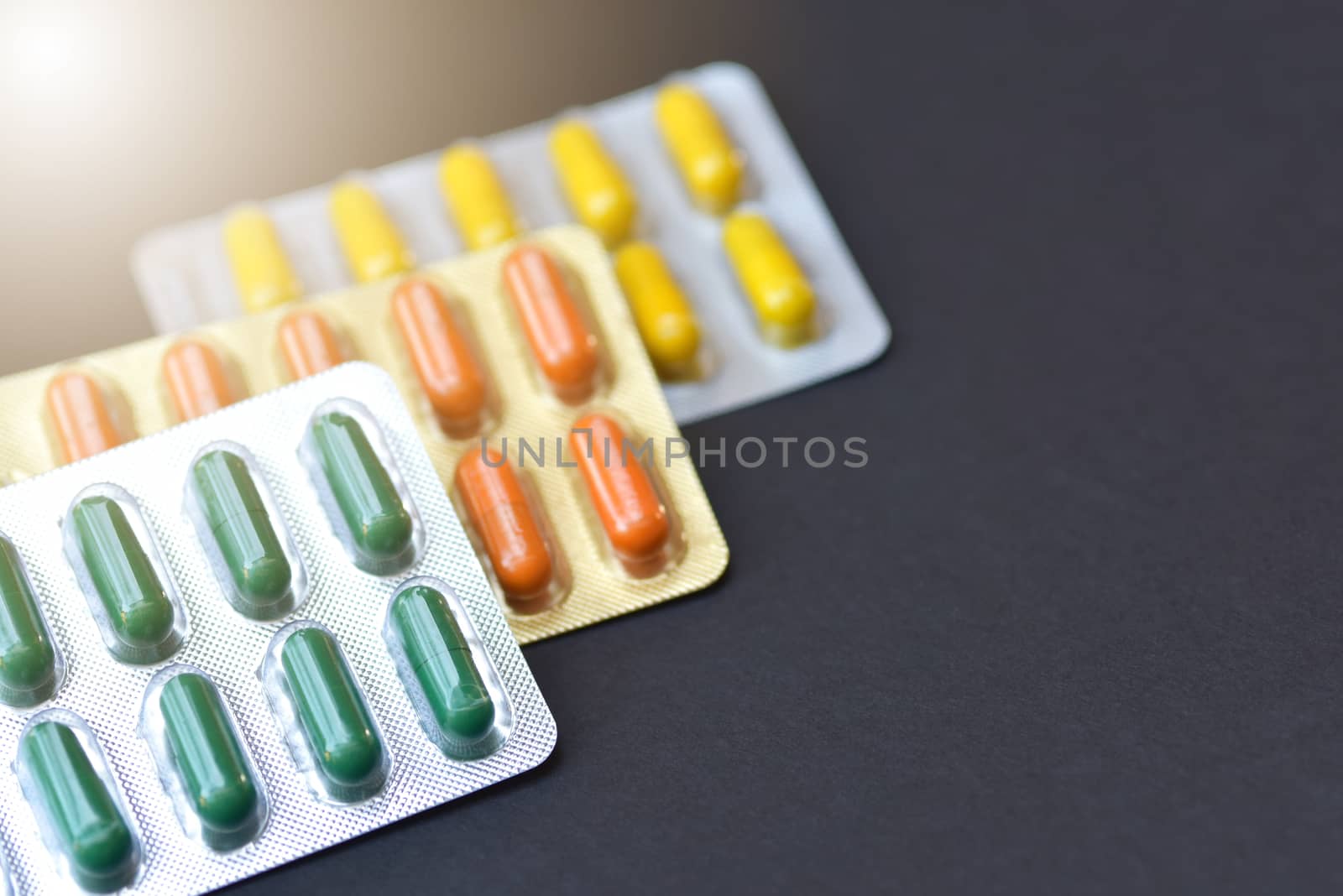 Pharmaceutical capsules pills in blisters packaging isolated on Black background with copy space for text. Thai herbal medicine for anti inflammatory, muscle relaxant and pain. selective focus