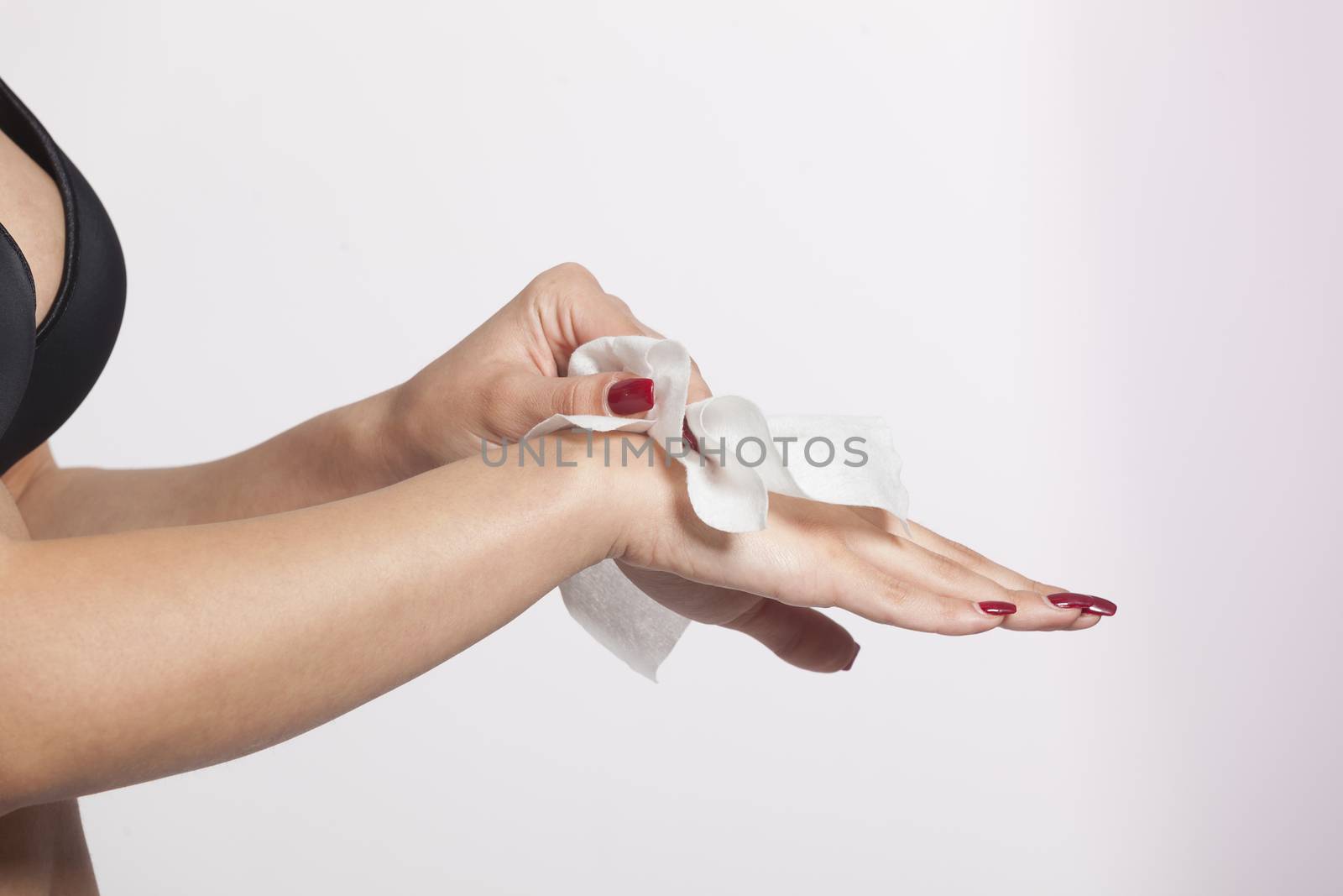 Young woman clean hands with wet wipes