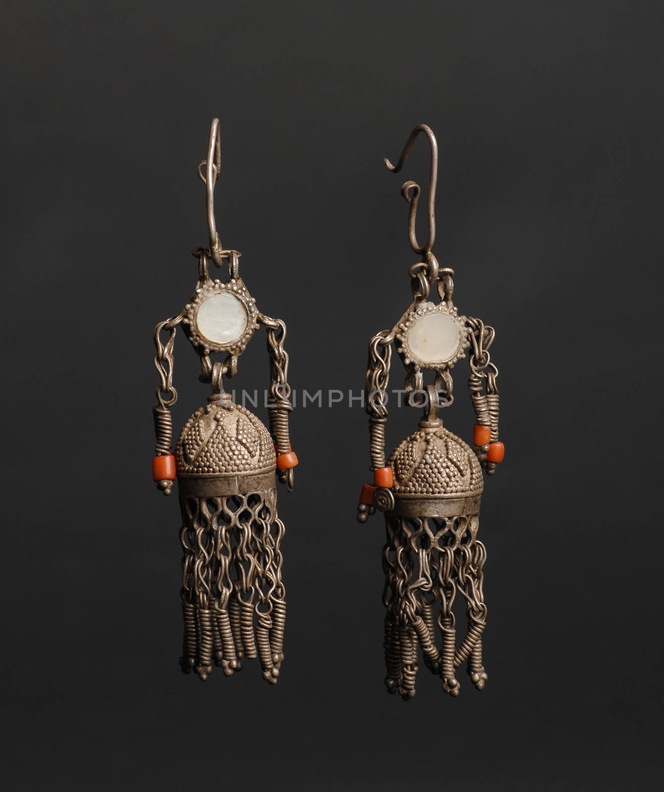 ancient antique earrings with stones on black background. Middle-Asian vintage jewelry