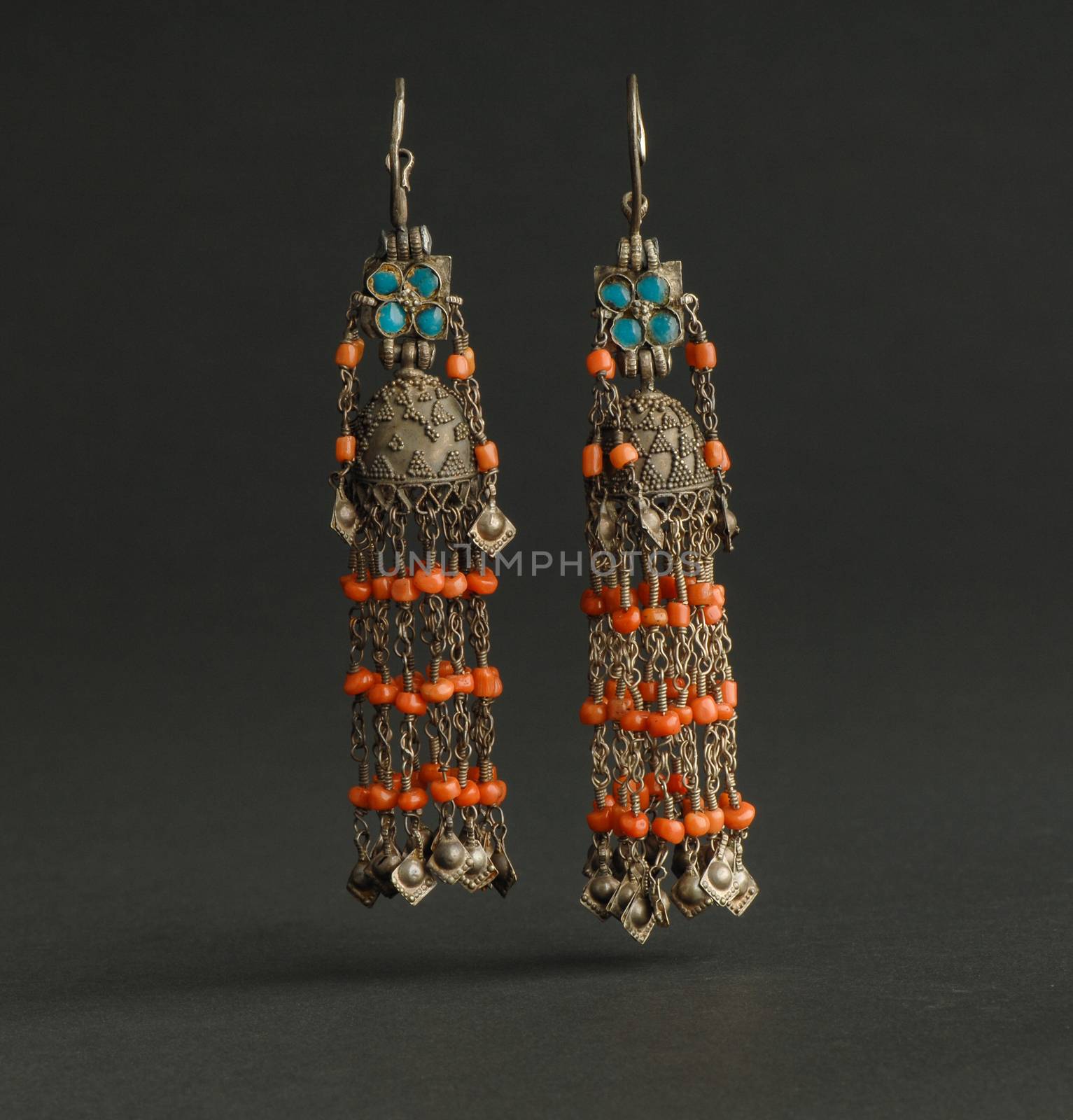 ancient antique earrings with stones on black background. Middle-Asian vintage jewelry