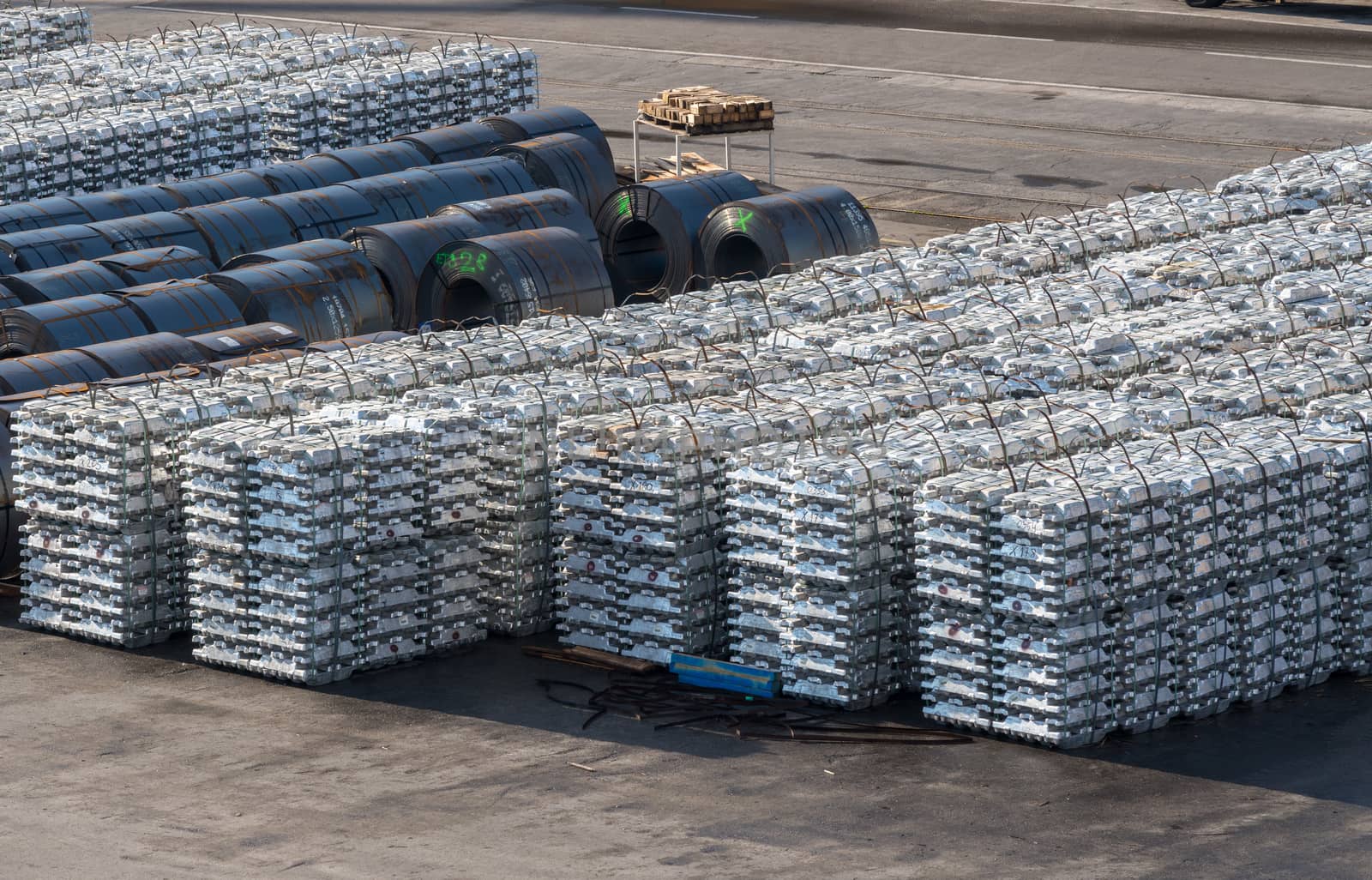 Ingots of aluminum and rolls of steel line the quayside in the Port of Koper in Slovenia