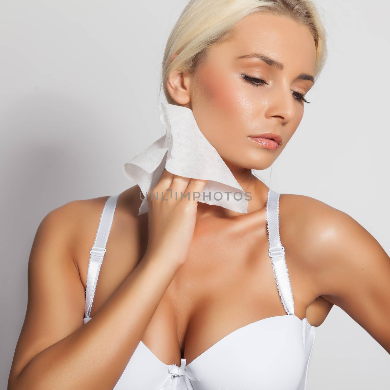 Young woman clean neck with wet wipes, body breast lingerie