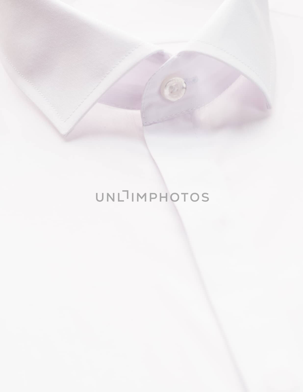 white shirt with focus on collar and button, close-up