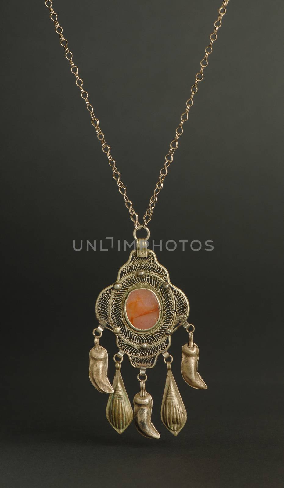 ancient antique pendant with stones on black background. Middle-Asian vintage jewelry