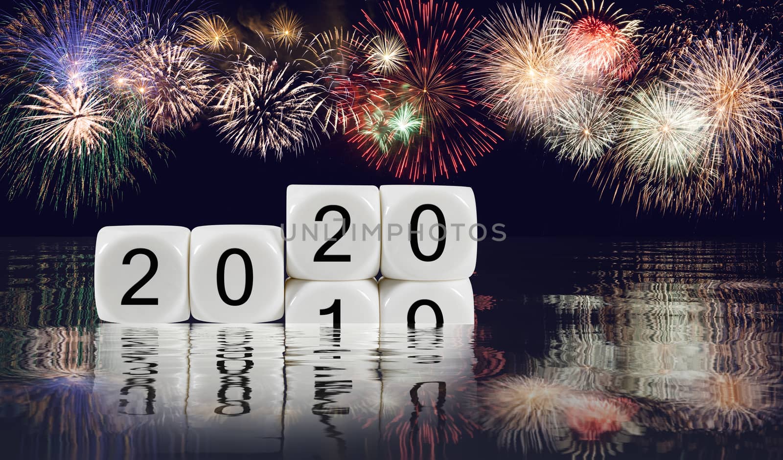 Composite of multiple firework explosions with calendar blocks showing 2019 sinking into the ocean as 2020 starts