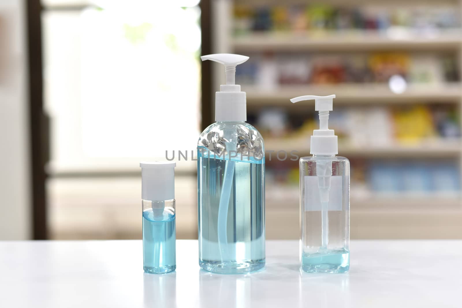 alcohol gel for hand wash. hand sanitizer gel for hygiene corona virus protection and medical. medicine bottles in blue tone People using alcohol gel to wash hands to prevent COVID-19 virus For office