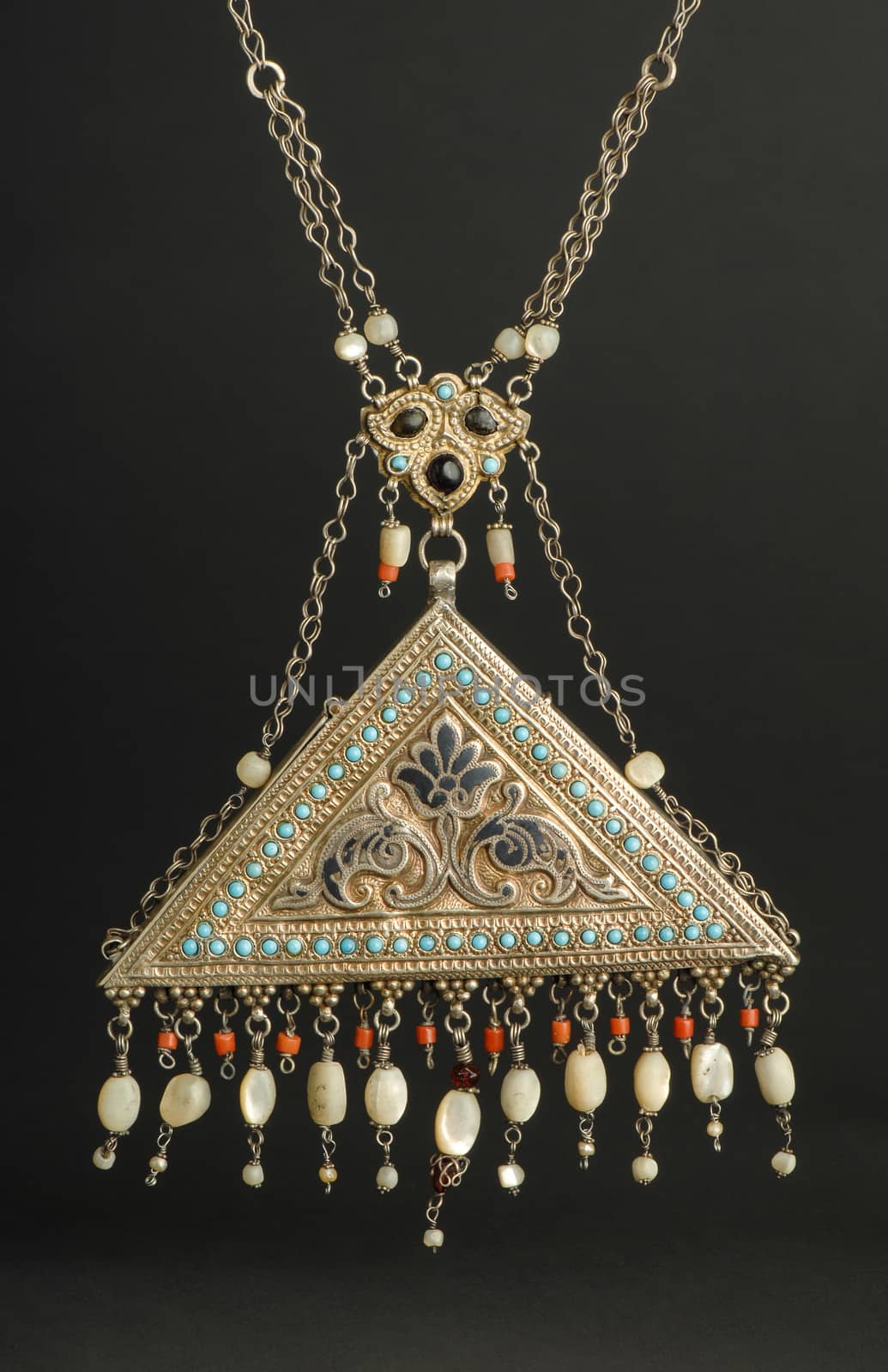 ancient antique pendant with stones on black background. Middle-Asian vintage jewelry