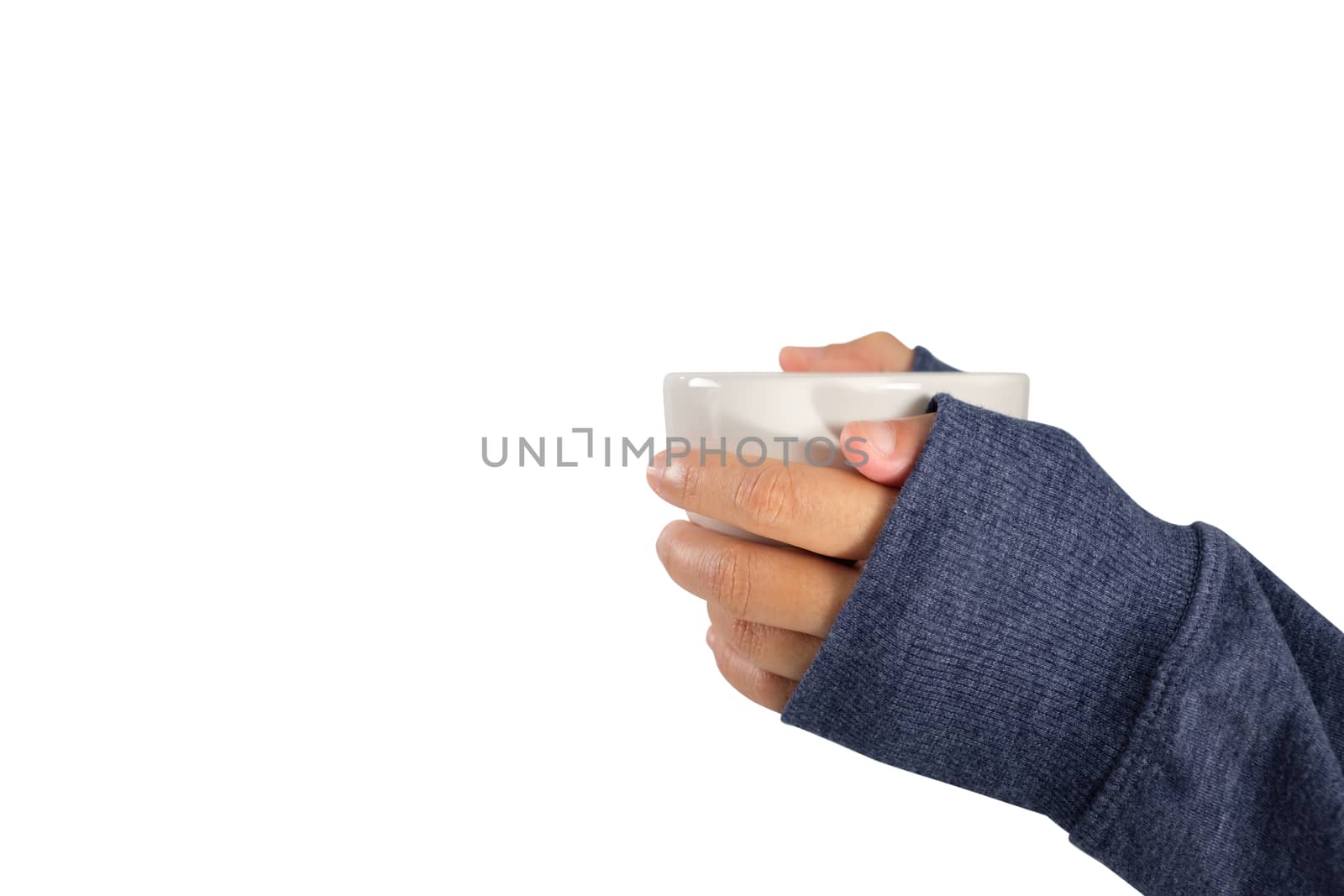 Girl's hand in sweater holding a cup of coffee isolated on white background.