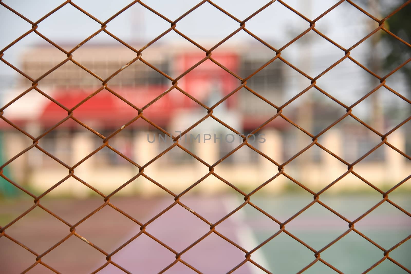 Beautiful view of Background texture of old rusty wire mesh. Cut off picture, horizontal, place for text, no people. Conception of construction and safety at sunset. Selected focus
