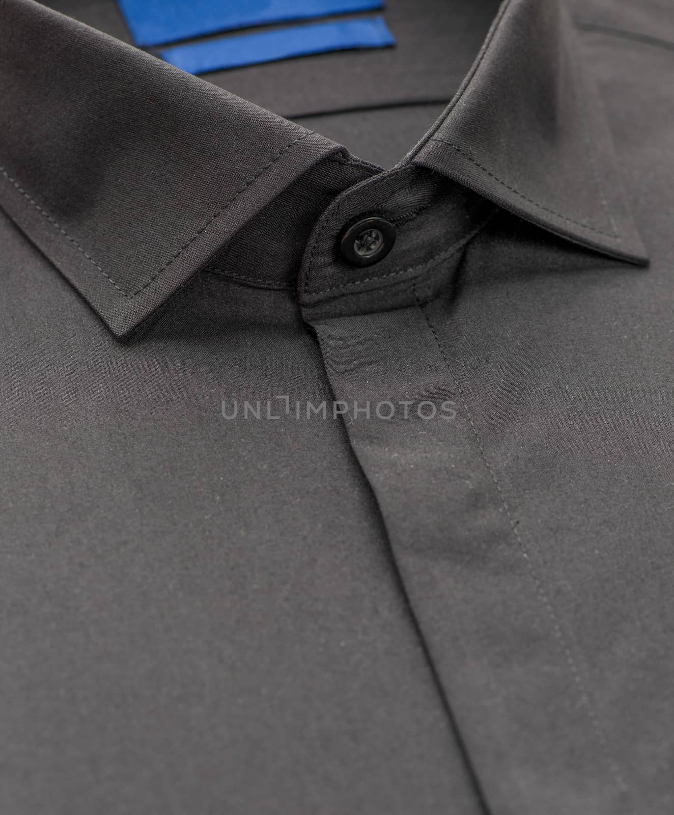 black shirt with focus on collar and button, close-up