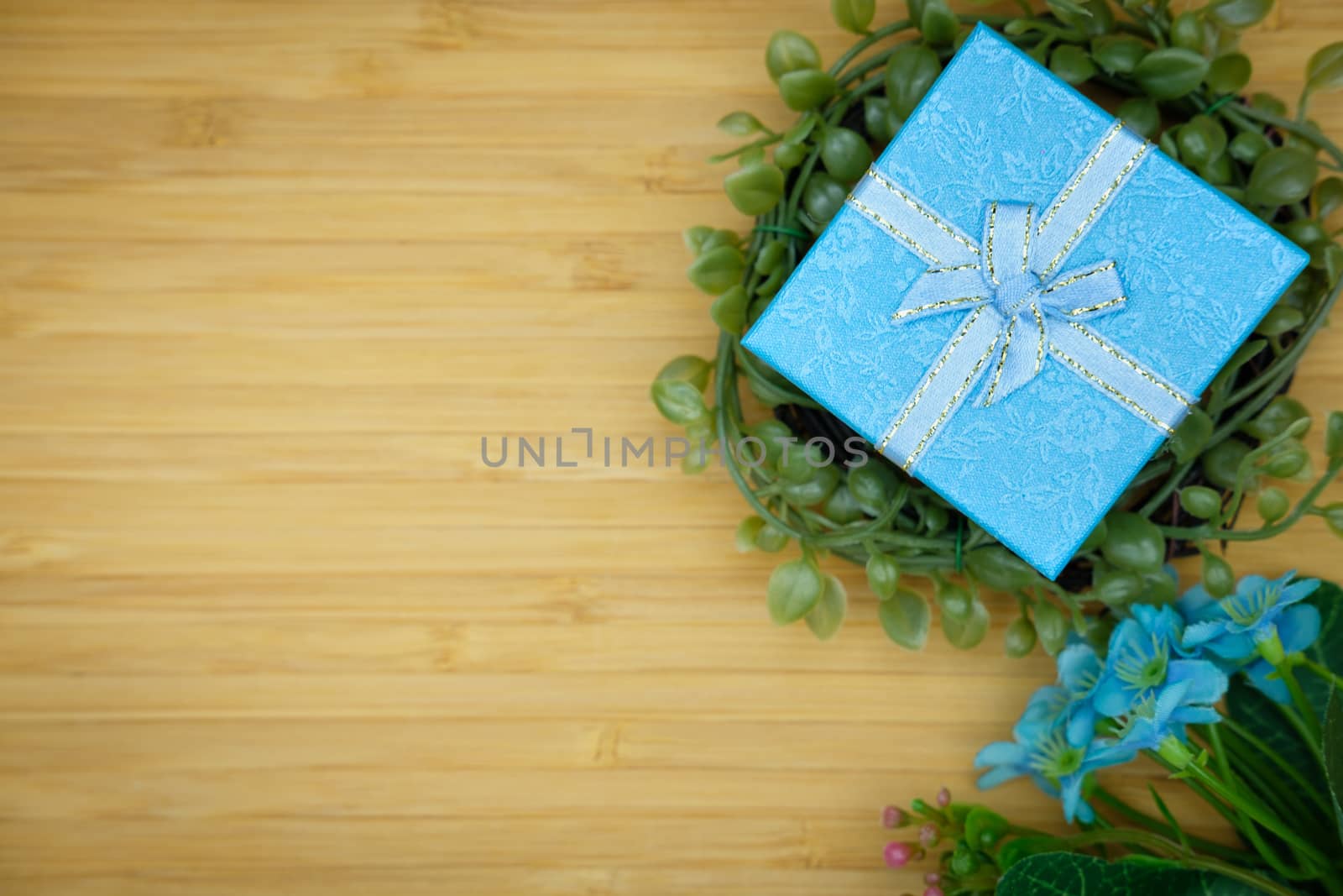 Gift box with as a present for Christmas, new year, valentine day or anniversary on wooden background, top view, space for write.
