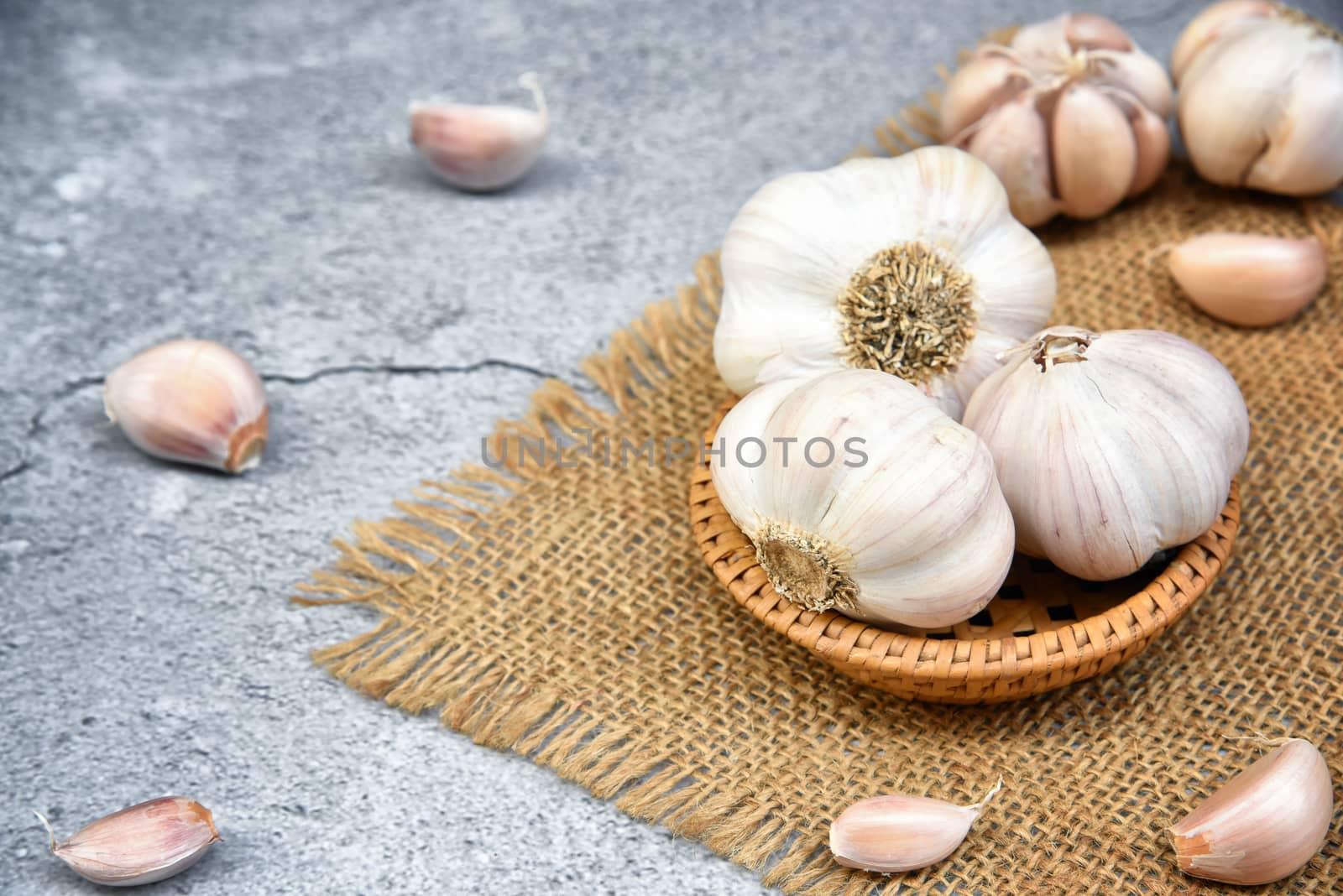 Organic Garlic. Fresh Garlic Cloves and Garlic bulb in wooden ba by C_Aphirak