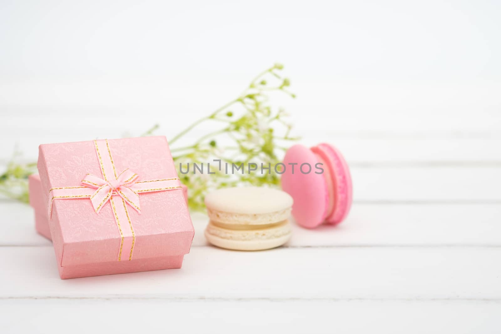 Gift box and macarons on whie table background with copy space to write.