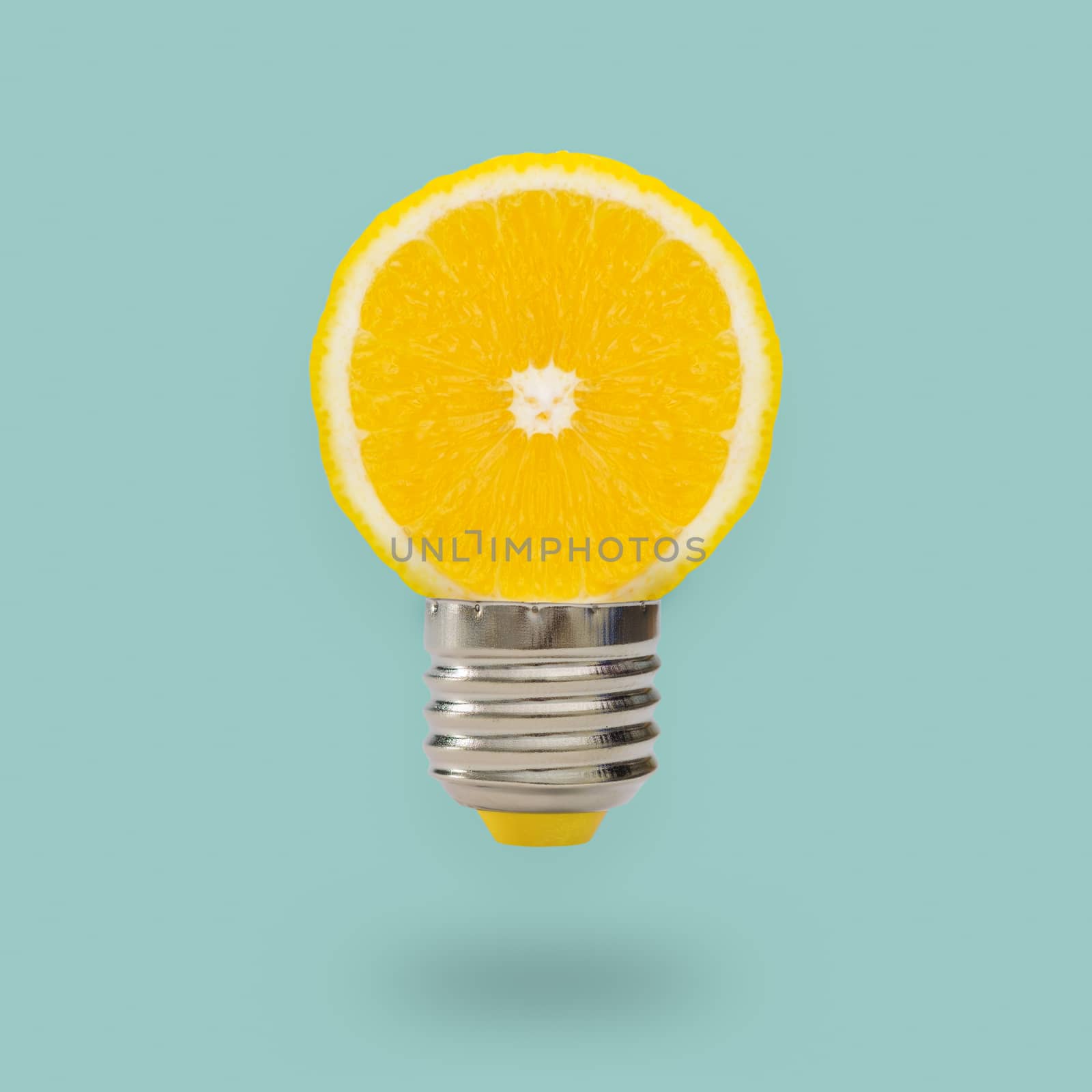 Yellow Lemon light bulb on bright blue background. Summer fun concept.