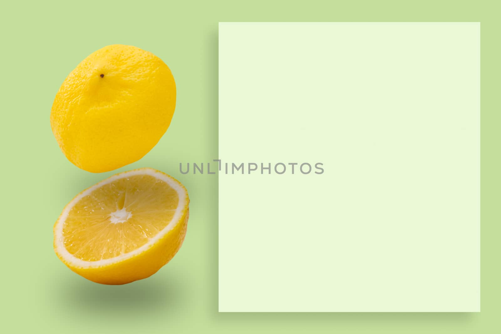 Lemon slices pattern on green background. Food concept.