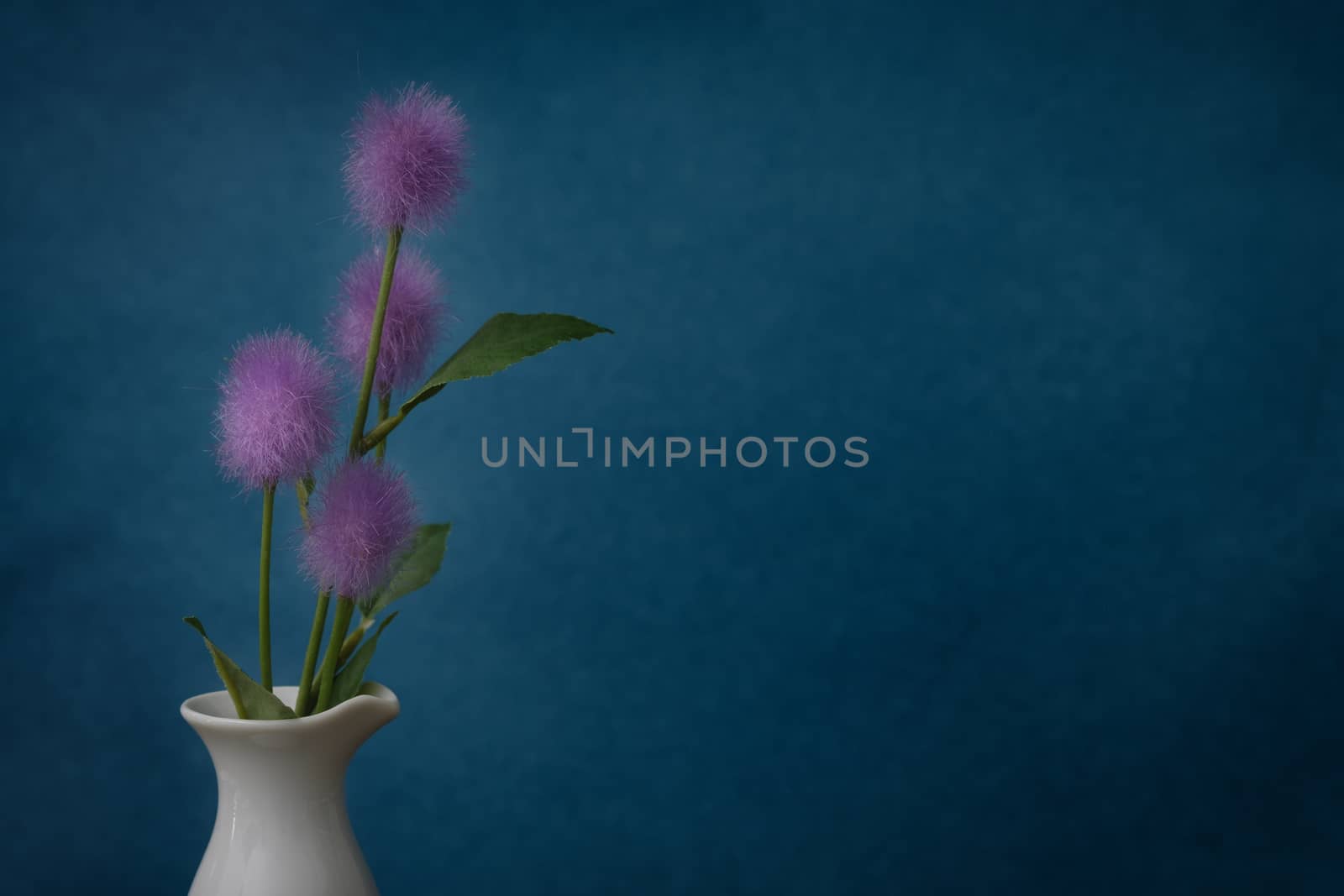 Still life with flower in the ceramic vase on rustic blue background, Choose a focal point, copy space for write.