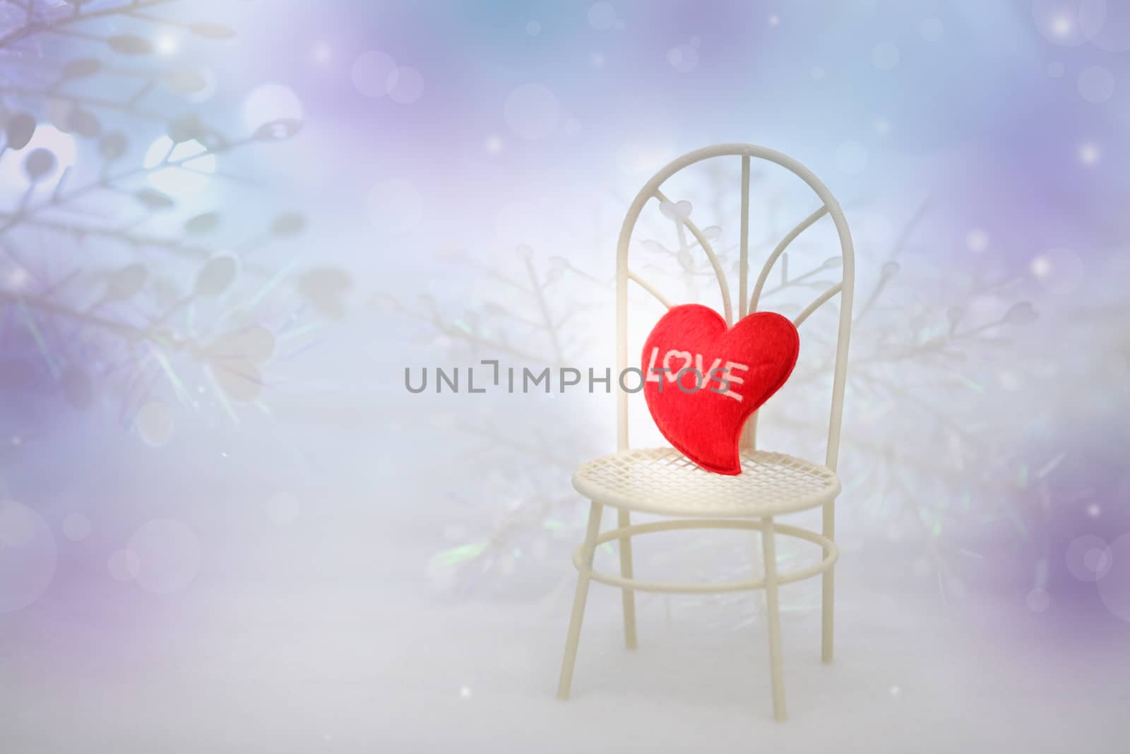 The red Heart shapes on white chair in abstract bokeh background in love concept for valentines day with romantic moment.