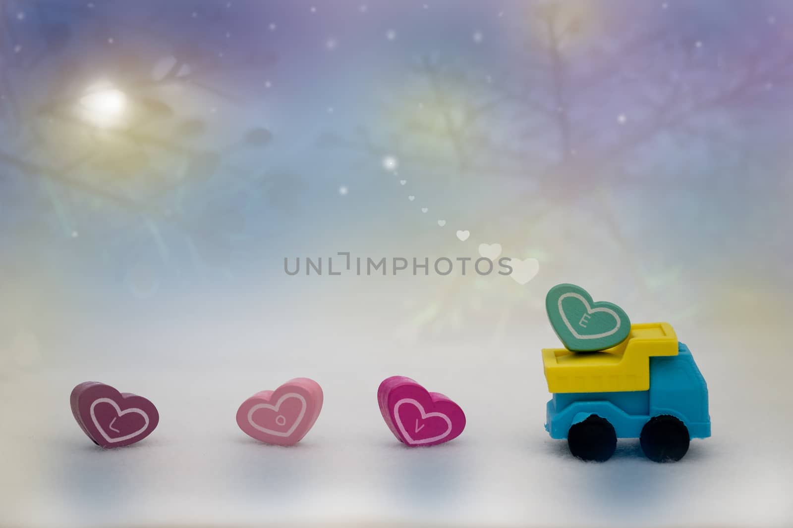 Heart shape on toy truck in bokeh background, with copy space for season greeting, valentine concept, AF point selection,blurred.