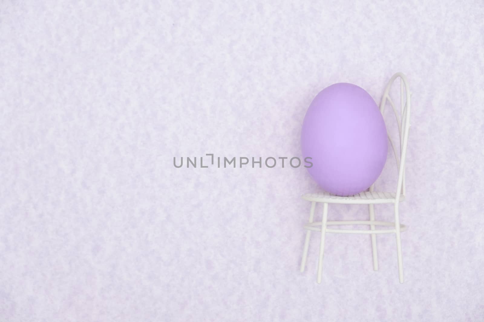 Egg shell on purple background. Minimal and easter concept, with copy space to write.