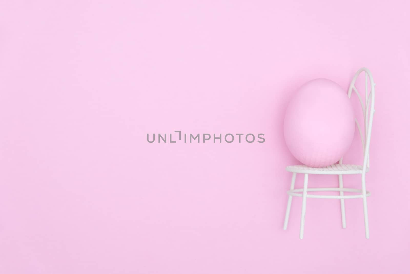 Egg shell on pink background. Minimal and easter concept, with copy space to write.