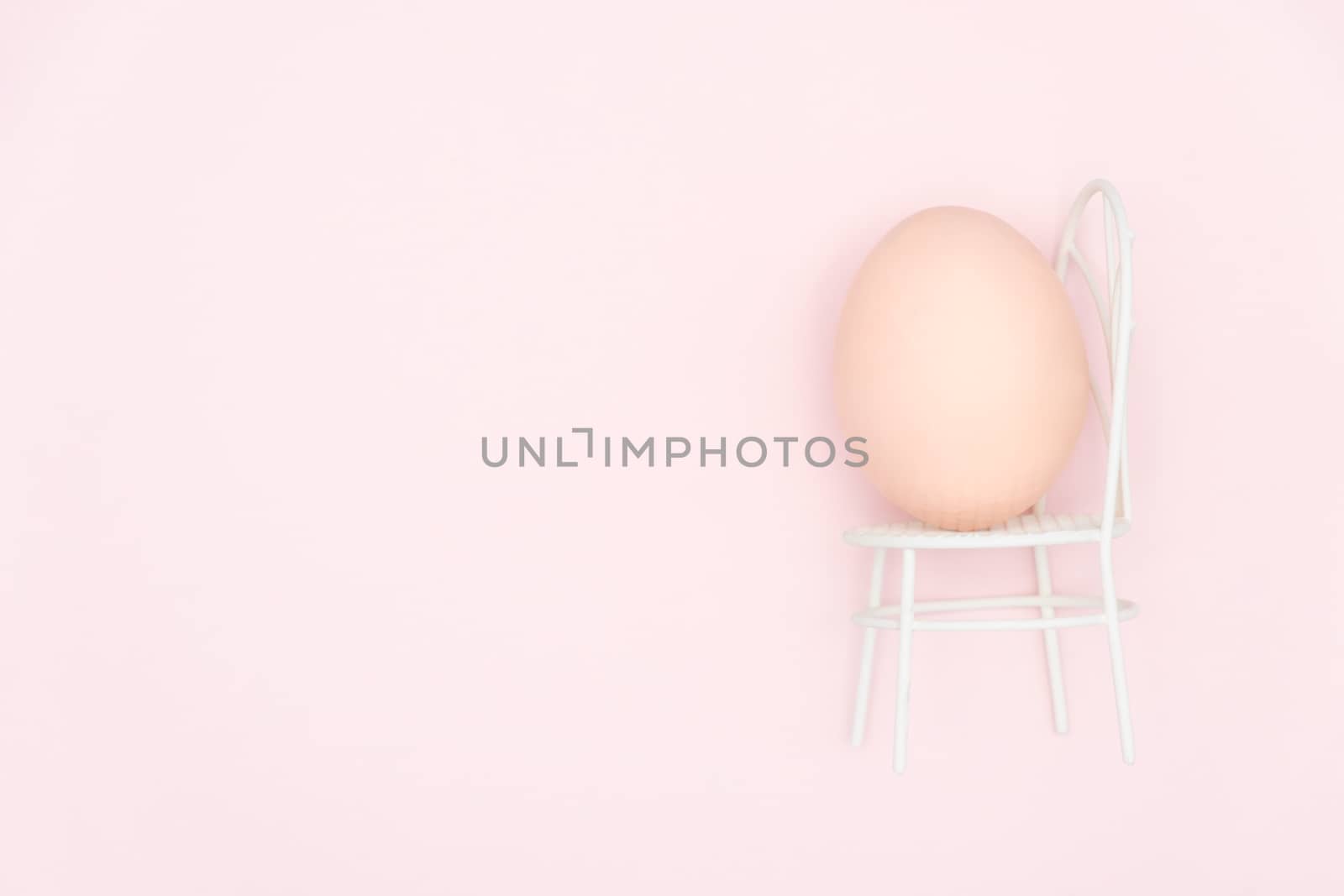 Egg shell on pink background. Minimal and easter concept, with copy space to write.