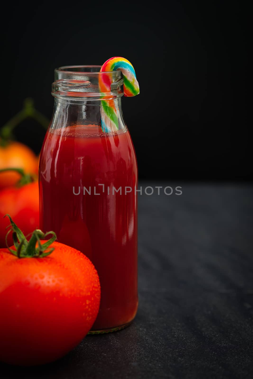 Still life of fresh ripe tomatoes juice on wooden background, Choose focus point. Good health concept.  Vertical picture style.