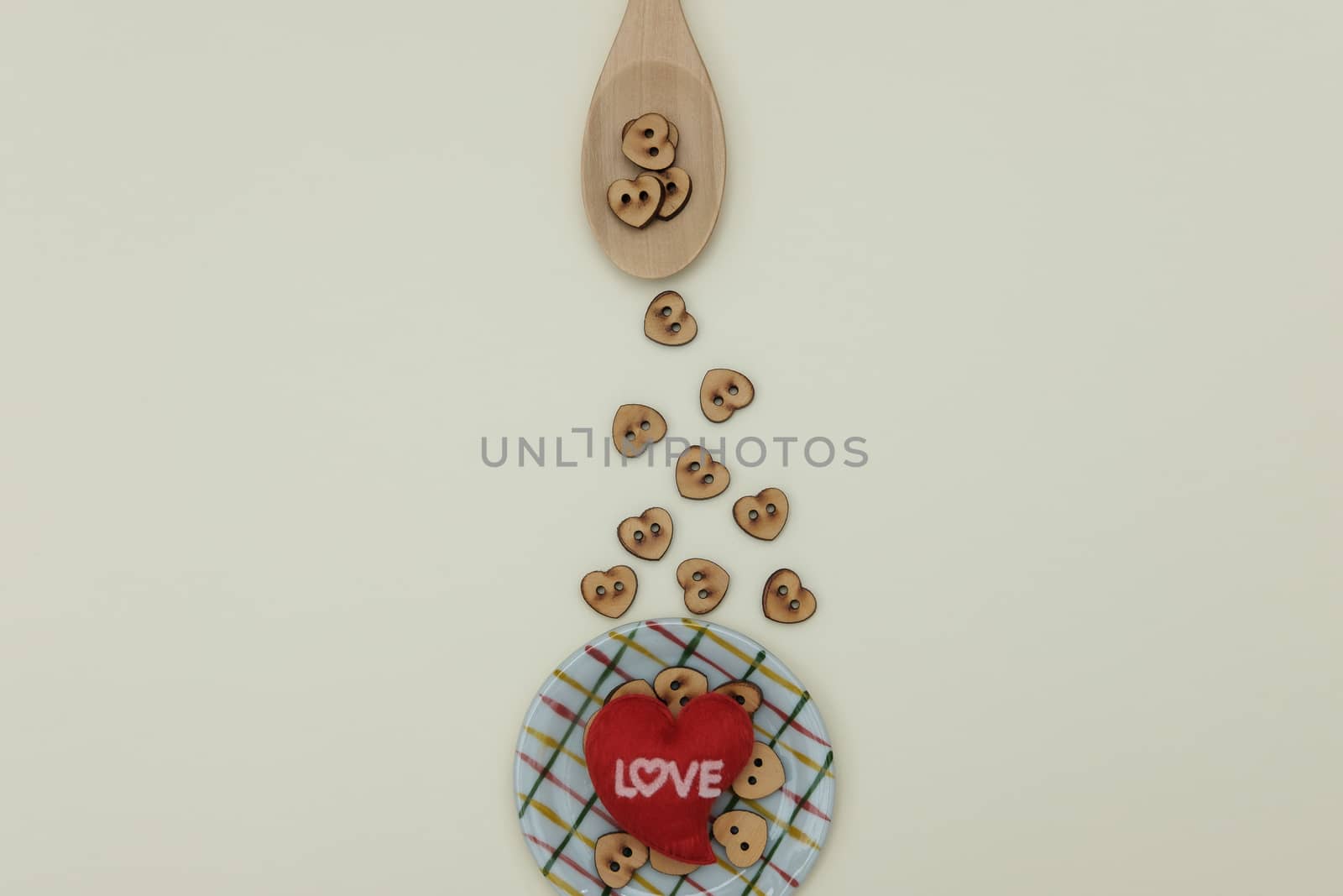 Wooden spoon sprinkle granules heart to dish on yellow background, Flat lay and valentine  concept.