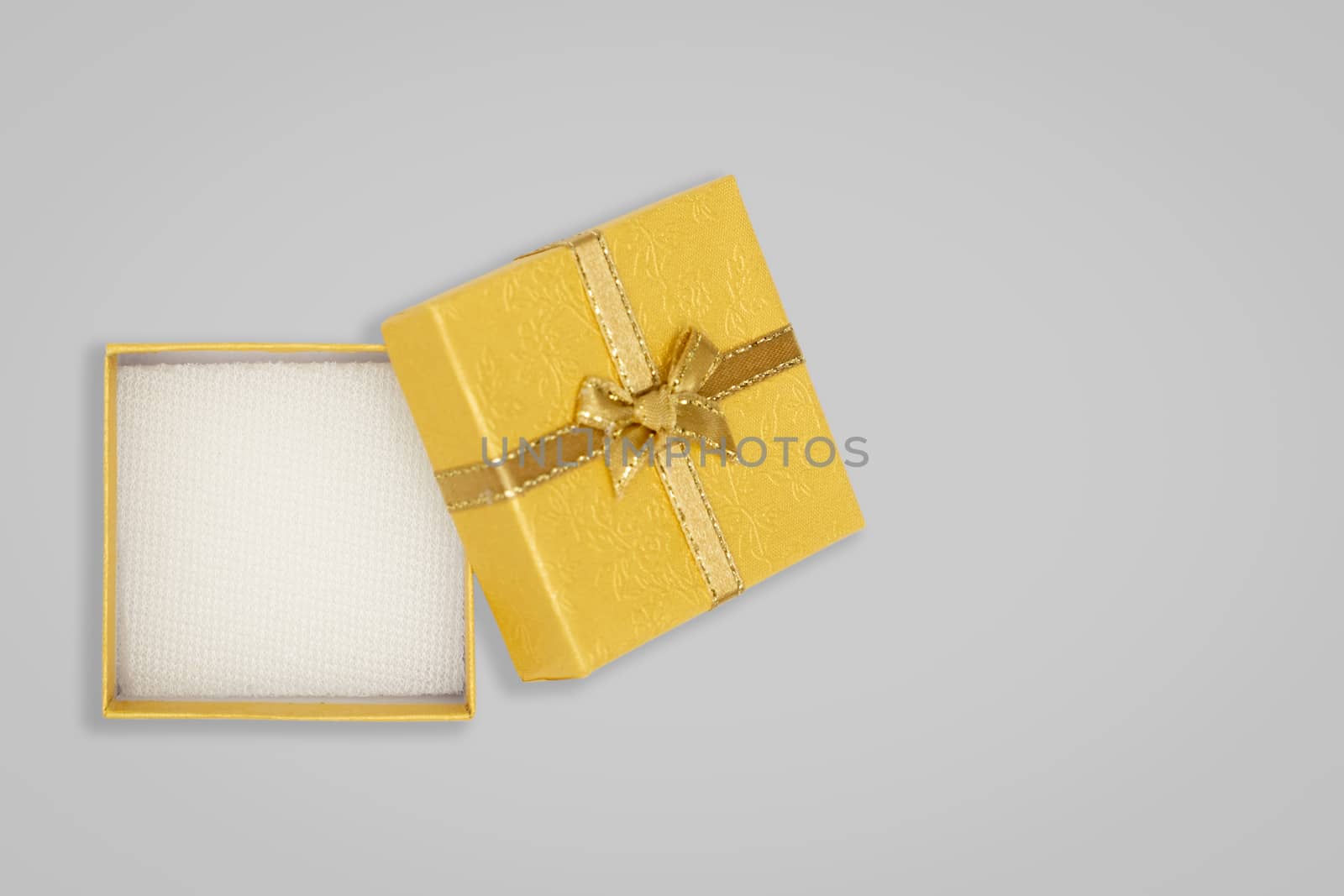 Top view of opened yellow gift box on glay background. with copy space for text.