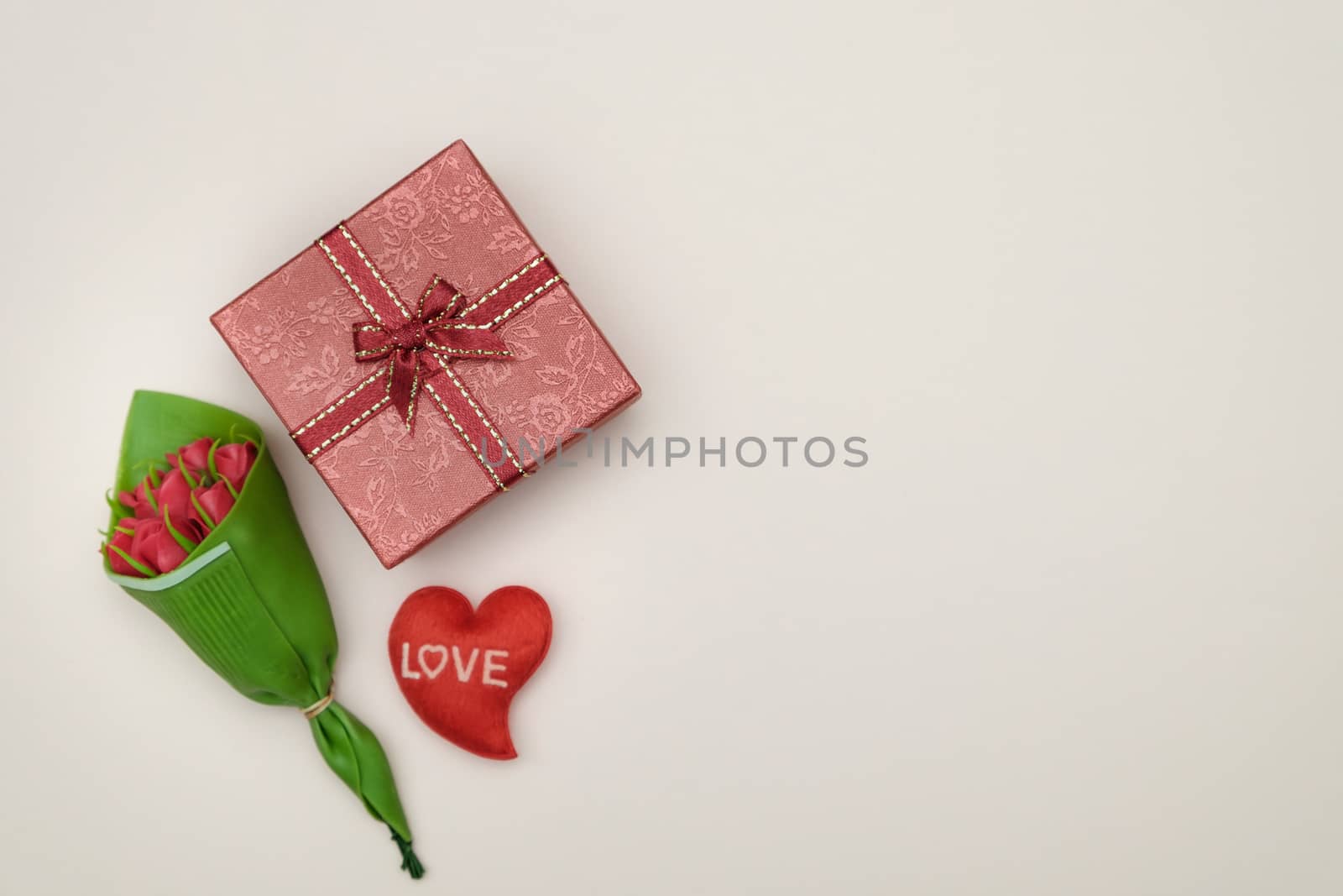Bouquet of roses and gift box on yellow background with valentine concept, copy space for write.
