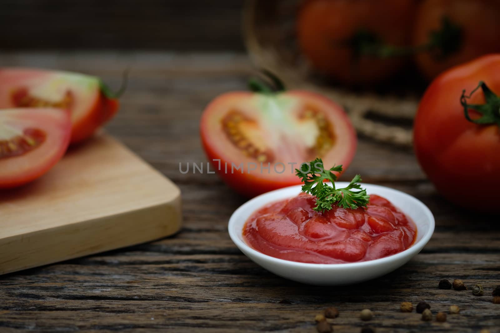Still life of fresh ripe tomatoes sauce on wooden background,  by feelartfeelant