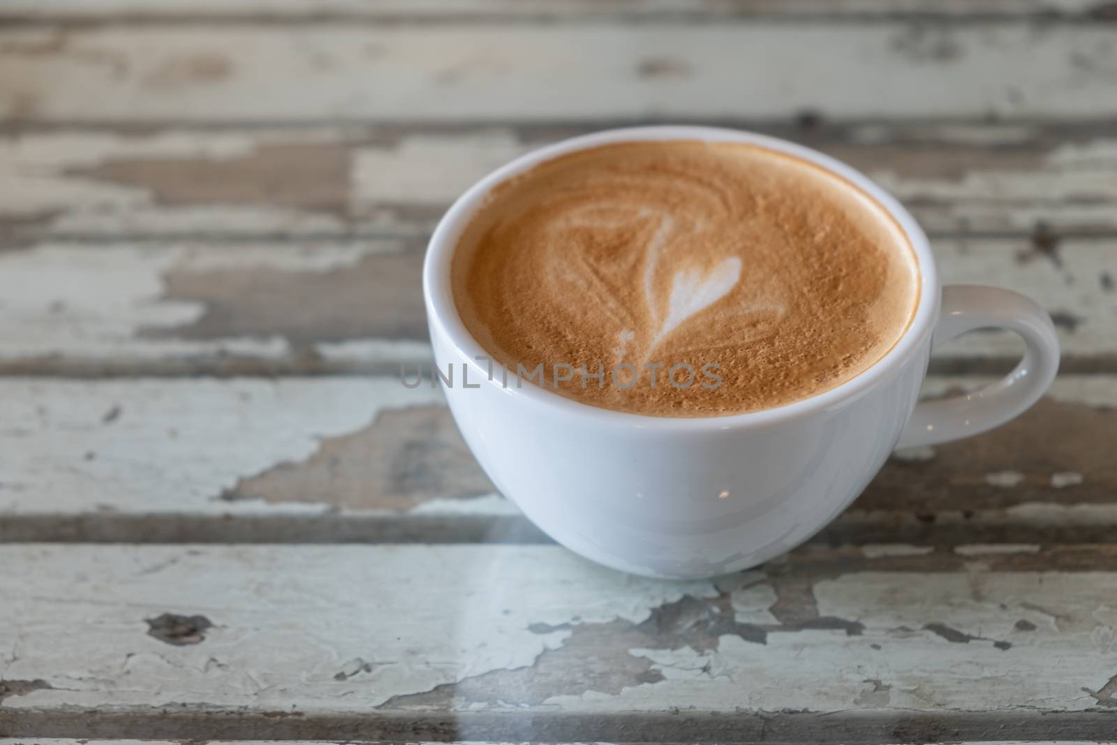 Hot coffee with frothy foam in white mug, Coffee Time.