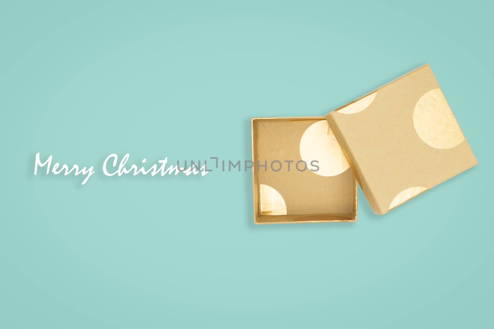 Top view of opened golden gift box on green background. with cop by feelartfeelant