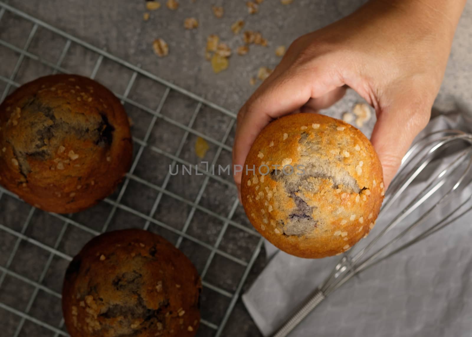 Hands holding a muffin look delicious.  by feelartfeelant