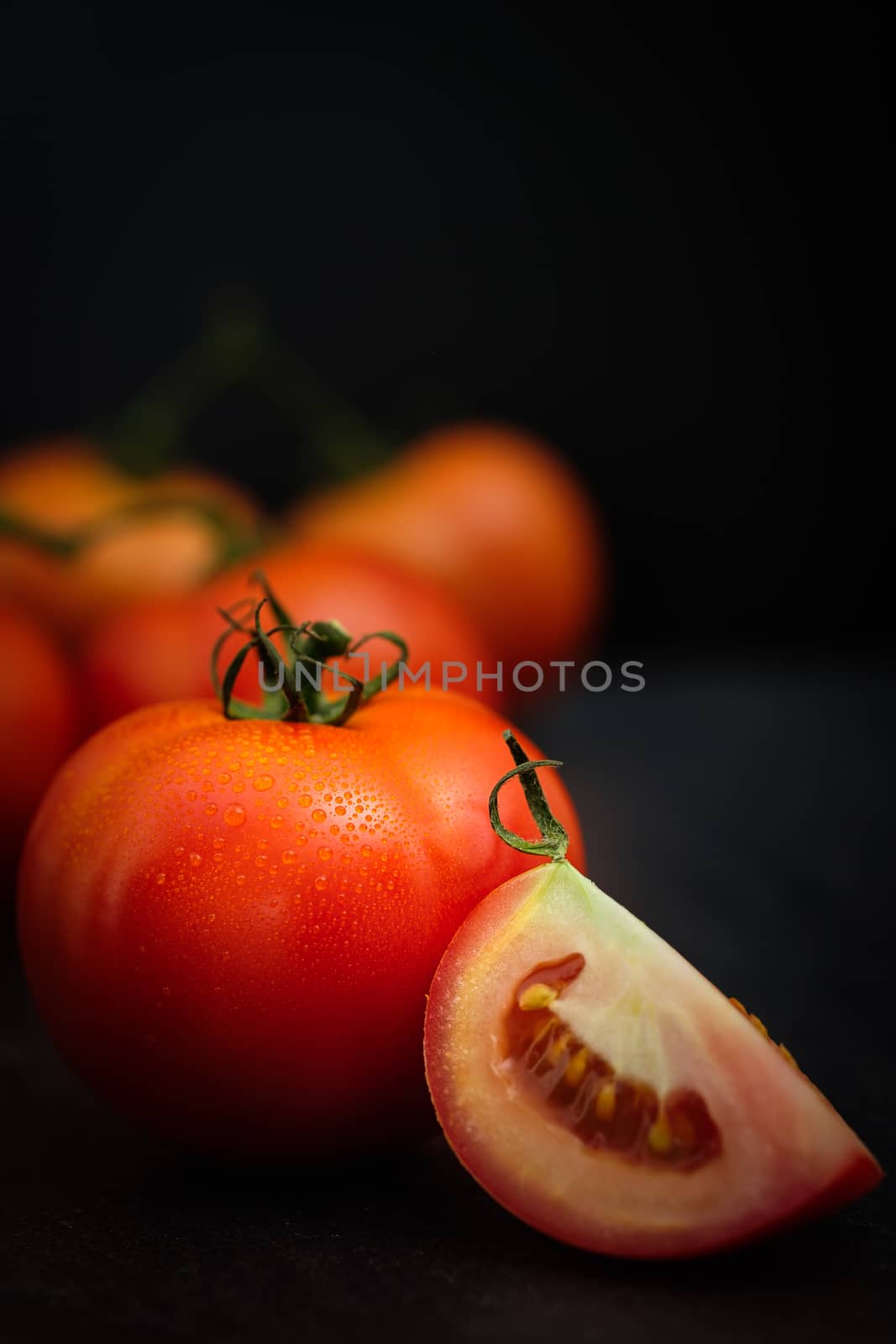 Still life of fresh ripe tomatoes on wooden background, Choose focus point. Good health concept.  Vertical picture style.