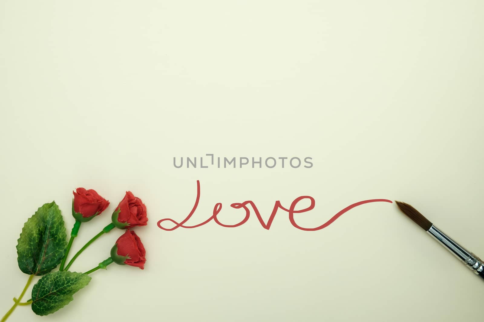 Write the word love with paintbrush on yellow background, valentine concept.